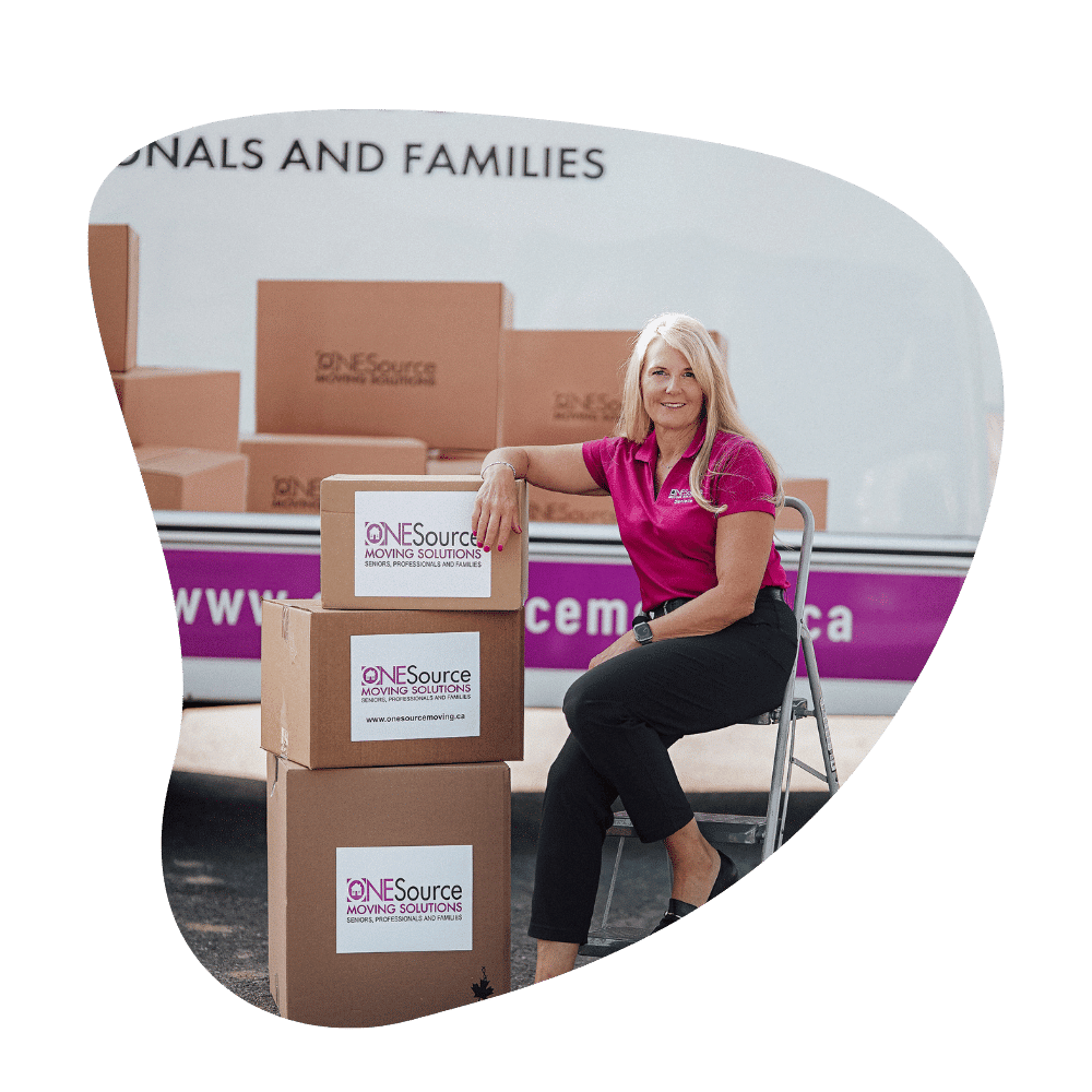 Danielle Welling leaning against a ladder and moving boxes